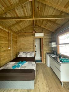 a bedroom with a bed in a wooden cabin at Floripa Glamping in Florianópolis +17 photos