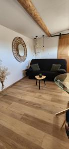 a living room with a couch and a table at Loft Q-PIDON in Saint-Laurent-la-Vernède