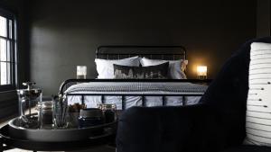 a bedroom with a bed and a table with a chair at Smiths Townhouse in Broadstairs +9 photos