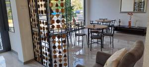 a restaurant with tables and chairs in a room at Ivan's guesthouse in Paraćin