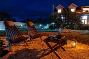 two chairs and a table with wine glasses on it at My Dalmatia - Villa Marijana in Radonić +72 photos