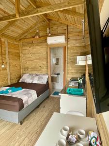a bedroom with a bed in a wooden cabin at Floripa Glamping in Florianópolis