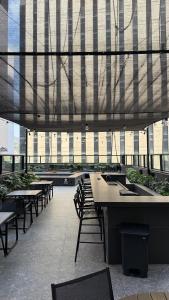 a cafeteria with tables and chairs in a building at Studio 4pessoas, WiFi, Sauna, Enxoval, Arcos da Lapa, a 5 minutos da Petrobras, próximo a VLT e Metro para Copacabana in Rio de Janeiro