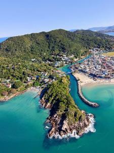 an aerial view of a small island in the water at Floripa Glamping in Florianópolis