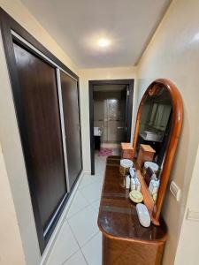 ein Badezimmer mit einem Waschtisch aus Holz und einem Spiegel in der Unterkunft Fade House in Temara