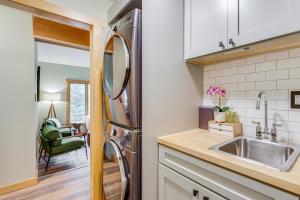 a kitchen with a sink and a stainless steel refrigerator at Riverbend Retreat on 7 Acres with River Access! in Webster +24 photos