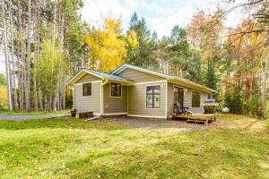 a tiny house in the middle of a yard at Riverbend Retreat on 7 Acres with River Access! in Webster