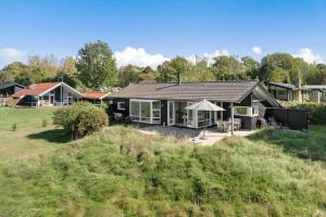 a house on a hill with a yard at 20225-Samso-Rosenvej-9 in Tanderup