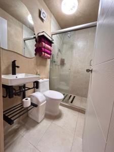 a bathroom with a toilet and a sink and a shower at Eclipse in Guadalajara