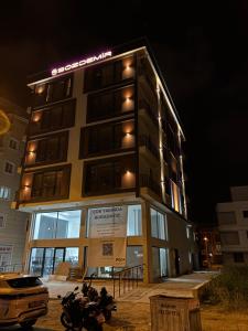 a building with motorcycles parked in front of it at night at Lighthouse Suite in Atakum