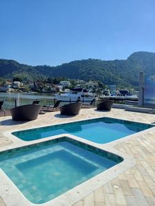 a swimming pool with a view of the water at Jet Club Marine - Angra dos Reis in Angra dos Reis +19 photos