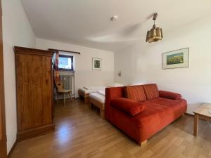 a living room with a couch and a bed at ciao-aschau FeWo Fey in Aschau