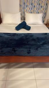 a bed in a room with a blue mattress at Les gîtes Lanmou 1 in La Désirade