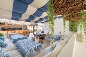 restauracja z niebieskimi i białymi stołami i krzesłami w obiekcie Aurora Boutique Hotel - Only Adults w Marbelli