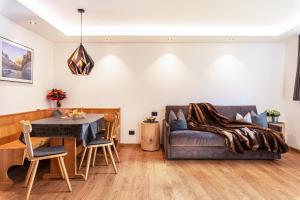 a living room with a couch and a table at Villa Erina App C3 in Ortisei