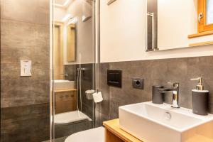 a bathroom with a sink and a toilet and a shower at Villa Erina App C3 in Ortisei