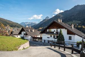a group of buildings with mountains in the background at Villa Erina App C3 in Ortisei