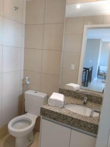 une salle de bain avec toilettes, lavabo et miroir dans l'établissement Beverlly Hills, à Aquiraz