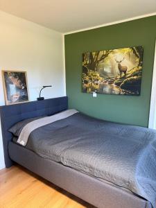 a bedroom with a bed with a picture of a deer on the wall at Wohnung mitten im Salzkammergut in Ohlsdorf