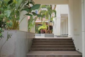 a set of stairs in a building with plants at Modern 1BHK by Kastra Homes, Siolim in Cunchelim