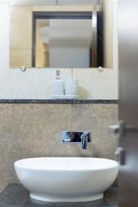 a white sink in a bathroom with a mirror at Modern 1BHK by Kastra Homes, Siolim in Cunchelim +22 photos