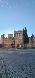 a large castle with a road in front of it at Pérola Azul de Alter do Chão in Alter do Chão