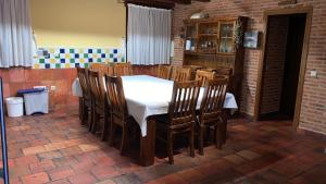 a dining room with a white table and chairs at La Tarja I y II in Martín Miguel +4 photos