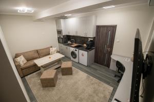 a small living room with a couch and a kitchen at Апартамент Милена in Smolyan