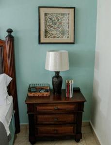 a lamp on a dresser next to a bed at Costa Bonita Private Villas in Culebra +28 photos