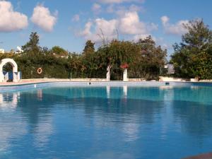 a large swimming pool with blue water at Siesta Mar Apartamentos Ibiza in Santa Eularia des Riu