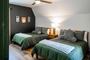 a living room with two beds and a couch at The Evergreen A-Frame in Helen +52 photos