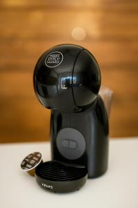 a black hair dryer sitting on a table at Maison f2 rouge in Saint-Leu