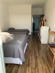 a bedroom with a bed and a wooden floor at Hospedaria Colinas in Indaiatuba +30 photos