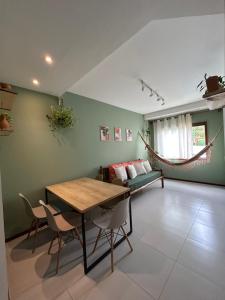 a living room with a table and a couch at Casa Luminah in Itacaré +22 photos