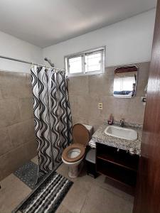 a bathroom with a toilet and a sink and a shower at Mar 11 -ALOHA in Parque del Plata