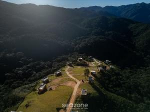 an aerial view of a farm in the mountains at Cabana c/ vista e jacuzzi Serra Catarinense VST025 in São Paulo dos Pinhais