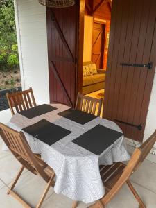 a table and chairs on a porch with a door at Les gîtes Lanmou 2 in La Désirade