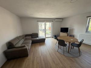 a living room with a couch and a table at Bee apartman in Odorheiu Secuiesc