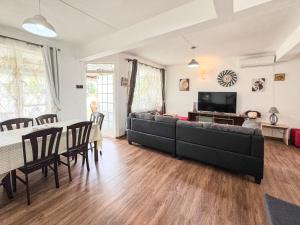 a living room with a couch and a table at Beachfront Villa near Mont Choisy Beach in Grand Baie