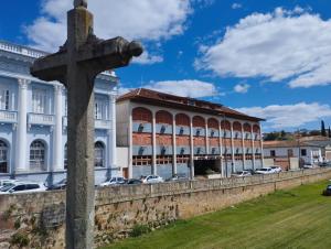 a cross in front of a large building at Hotel Ponte Real in São João del Rei