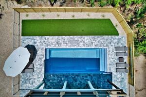 an overhead view of a swimming pool with an umbrella at Endless Summer St George 4Bed 3 5 Bath with POOL in St. George Island