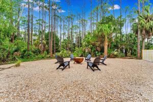 a group of chairs sitting on a gravel patio at Endless Summer St George 4Bed 3 5 Bath with POOL in St. George Island