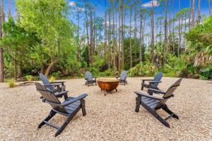 a group of chairs and a table with a wooden bowl at Endless Summer St George 4Bed 3 5 Bath with POOL in St. George Island