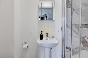 a white bathroom with a sink and a shower at NOW OPEN! Brand new rooms City Centre Modern Ensuite Rooms by Luxiety Stays in Cambridge