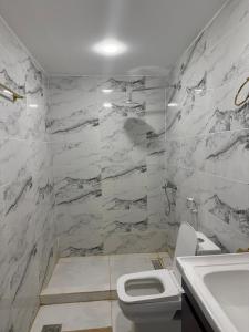 a bathroom with a white toilet and a sink at WADI RUM GUlDE , CAMP & TOUR in Wadi Rum