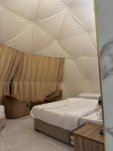 a bedroom with two beds in a tent at WADI RUM GUlDE , CAMP & TOUR in Wadi Rum +23 photos