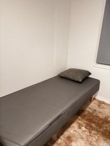 a bed sitting in a corner of a room at Norway Lights center of Bodo near Train station and Aeroport in Bodø