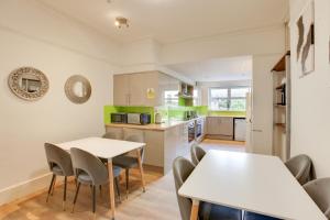 a kitchen and dining room with a table and chairs at NOW OPEN! Brand new rooms City Centre Modern Ensuite Rooms by Luxiety Stays in Cambridge +23 photos