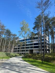 an external view of a building with trees at Apartament Krab AKTENA Shellter Rogowo in Rogowo