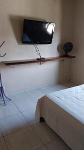 a room with a flat screen tv on a wall at Sobrado entrada de Paraty in Paraty